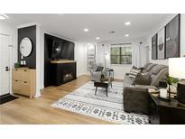 Cozy living room featuring a fireplace, comfortable seating, and stylish decor at 107 Barrington Hills Dr, Atlanta, GA 30350