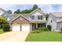 Charming two-story home featuring a brick facade, gray shutters, a two-car garage, and a well-manicured front yard at 167 Diamond Ridge Ave, Canton, GA 30114
