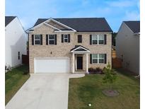 Charming two-story brick home with a well-maintained lawn and a two-car garage in a Gathering-friendly neighborhood at 2159 Redfern Rd, Dacula, GA 30019