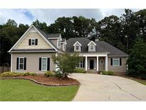 Charming traditional home featuring neutral siding, detailed trim, and a well-manicured front lawn at 237 Shockley Way, Dallas, GA 30157