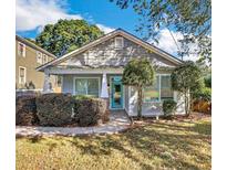 Charming bungalow with a blue door, manicured landscaping, and inviting front porch at 1283 Mercer, East Point, GA 30344