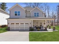 Charming two-story home with a welcoming front porch, two-car garage, and well-manicured lawn at 1784 Treymire Ct, Stone Mountain, GA 30088