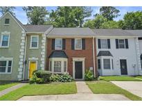 Charming brick townhome featuring well-maintained landscaping and a welcoming front entrance at 2941 Governors Ct, Marietta, GA 30066