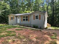 Charming single-story home with gray siding and wooden shutters nestled among mature trees at 4610 Wilson James Sw Rd, Atlanta, GA 30331