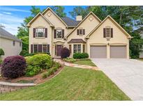 Charming two-story home featuring a well-manicured lawn and a two-car garage at 2864 Wyndcliff Ct, Marietta, GA 30066