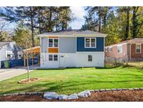 Charming two-story home with a well-manicured lawn and freshly painted exterior at 1270 Graymont Sw Dr, Atlanta, GA 30310