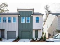 Charming two-story townhouse with a green front door and garage at 1648 Florence Nw Run, Atlanta, GA 30318