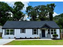 Charming one-story home with a freshly painted white brick exterior, dark shutters, and a well-manicured front yard at 1937 Don Juan Ln, Decatur, GA 30032