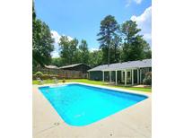 A pristine pool with cool blue water awaits in this home's backyard, promising relaxation and fun at 2913 Jordan Forest Trl, Lawrenceville, GA 30044