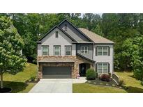 Charming two-story home with a stone-accented garage and manicured landscaping at 109 Red Fox Dr, Dallas, GA 30157