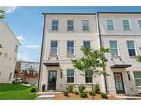 Charming three-story townhome with painted brick and manicured front yard at 3440 Hardy St, Duluth, GA 30096