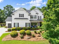 Charming two-story traditional home boasting a manicured lawn and tasteful landscaping at 2213 Independence Ln, Buford, GA 30519