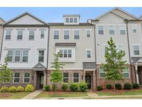 Charming townhome features brick accents, stylish siding, and professionally landscaped front yard at 377 Danville Ave, Suwanee, GA 30024