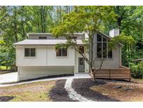 Charming home featuring a unique architectural design, complemented by lush landscaping at 515 Dover St, Marietta, GA 30066