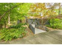 Charming home featuring a ramp walkway, stone accents, and lush landscaping, creating an inviting entrance at 5848 Kingswood Ct, Norcross, GA 30093