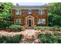 Charming brick home featuring manicured landscaping, a welcoming entrance, and classic architectural details at 27 S Avondale Rd, Avondale Estates, GA 30002
