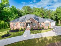 Charming brick home with well-manicured lawn and inviting walkway leading to the entrance at 338 Mount Zion Rd, Oxford, GA 30054