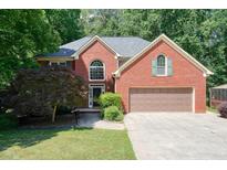 Charming two-story brick home with a two-car garage and a well-manicured front yard at 109 Lake Latimer Ne Cv, Kennesaw, GA 30144