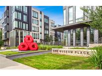 Modern exterior of One Museum Place features sleek architecture and well-maintained landscaping at 1301 Peachtree Ne St # 4L, Atlanta, GA 30309