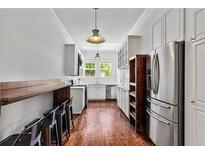 Bright kitchen features stainless steel appliances, hardwood floors, subway tile backsplash, and modern pendant lighting at 872 Briarcliff Ne Rd # B2, Atlanta, GA 30306