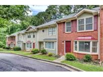 Inviting townhome with manicured lawns and colorful landscaping features at 306 Autumn Leaf Way, Norcross, GA 30093