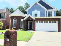 Charming two-story home featuring a two-car garage, brick accents, and a manicured lawn at 3473 Newtons Crest Cir, Snellville, GA 30078
