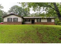 Charming one-story home with a brick foundation, neutral siding, and a well-manicured lawn at 265 Forest Lake Dr, Covington, GA 30016