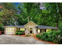 Charming brick home with lush landscaping, inviting entrance, and a well-maintained front yard at 5114 N Ivy Ne Rd, Atlanta, GA 30342