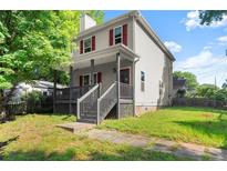 Charming two-story home featuring a covered front porch and well-maintained yard at 1902 Memorial Se Dr, Atlanta, GA 30317