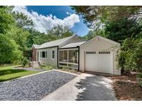 Charming home featuring a detached garage, screened porch, and well-manicured landscaping at 1131 Forrest Blvd, Decatur, GA 30030