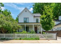 Charming two-story home with white picket fence, well-manicured lawn, and inviting front porch at 174 Pearl Se St, Atlanta, GA 30316
