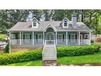 Charming home featuring a welcoming front porch, well-manicured landscaping, and a classic architectural design at 3358 Lake Dr, Lawrenceville, GA 30044