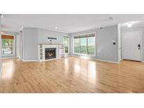 Spacious living room featuring a fireplace, hardwood floors, and natural light from large windows at 305 Mill Pond Se Ct, Smyrna, GA 30082