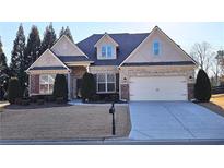 Charming home featuring a brick facade, well-manicured lawn, two-car garage, and inviting curb appeal at 6515 Bentley Ridge Dr, Cumming, GA 30040