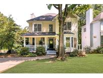 Charming two-story home with a welcoming front porch and a well-maintained lawn at 2653 W Main Nw St, Atlanta, GA 30318