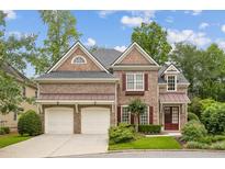 Charming brick home with a well-manicured lawn and two-car garage at 4046 Newhaven Ne Cir, Atlanta, GA 30319