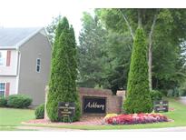 Community entrance sign surrounded by colorful flowers and greenery welcomes residents and visitors at 102 Ashbury Dr, Villa Rica, GA 30180