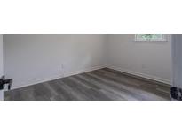 This bedroom features hardwood floors, fresh paint and a window view at 3570 Briar Dr, Lithia Springs, GA 30122