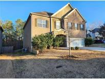 Charming two-story home with brick and siding exterior and well-maintained landscaping in a suburban setting at 5150 Amberland Sq, Atlanta, GA 30349