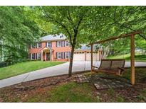 Charming two-story brick home with a three-car garage and a welcoming swing set at 1863 Wicks Valley Ne Dr, Marietta, GA 30062
