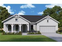 Charming single-story home showcasing board and batten siding, a welcoming front porch, and an attached garage at 580 Barnfield Way, Dallas, GA 30157