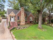 Charming brick home with stone accents, lush lawn, and inviting front entrance at 311 Glendale Ave, Decatur, GA 30030