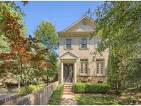 Charming two-story brick home featuring a manicured front yard, decorative door, and wrought iron details at 3663 Brookhaven Manor Crossing Ne, Atlanta, GA 30319
