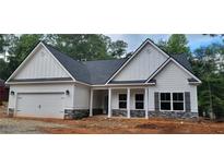 Charming single-Gathering home with stone accents, covered porch, attached garage, and a well-manicured lawn at 5502 Lakeview Parkway, Villa Rica, GA 30180