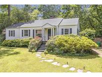 Charming single story home with landscaped front yard and stone walkway at 1908 E Roxboro Ne Rd, Atlanta, GA 30324
