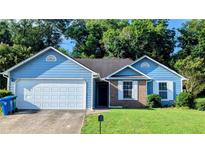 Charming one-story home with blue siding, brick accents, attached garage and well-maintained lawn at 1513 Foxhall Se Ln, Atlanta, GA 30316
