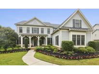 Charming two-story home with a manicured lawn and inviting front porch at 3705 Williams Point Dr, Cumming, GA 30028