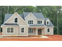 A charming two-story home displays a light exterior, a welcoming front porch, and a neatly manicured lawn at 4850 Cool Springs Rd, Winston, GA 30187