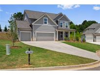 Beautiful two-story home with a three-car garage and well-manicured lawn at 6934 Melody Ridge Rd, Buford, GA 30518