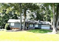 Charming single-story home with a well-maintained lawn and a two-car garage at 205 Trickum Hills Ln, Woodstock, GA 30188